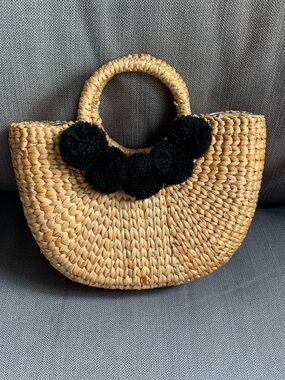 Woven Straw Handbag with Black Pom-Pom Accent